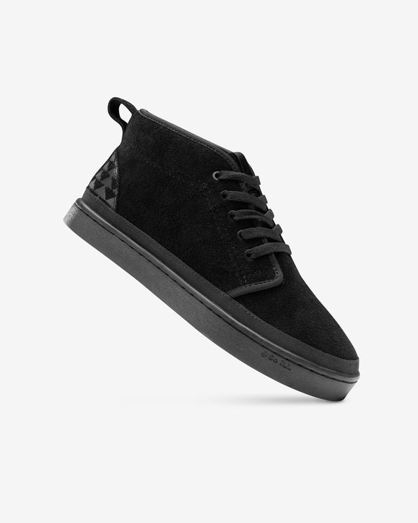 Black Wolf Chukka being displayed on a white background to showcase textures as well as the signature triangle tattoo pattern of Jason Momoa