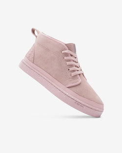 Dirty Pink Chukka being displayed on a white background tilted at an angle showing the exterior side of the shoe.