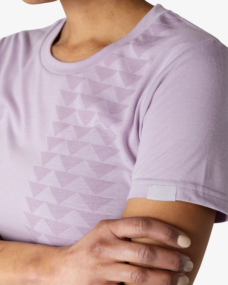 Close-up 3/4 view of the triangle pattern on the Yaya Lavender Nakoa Tee from So iLL x On The Roam, worn by a female model