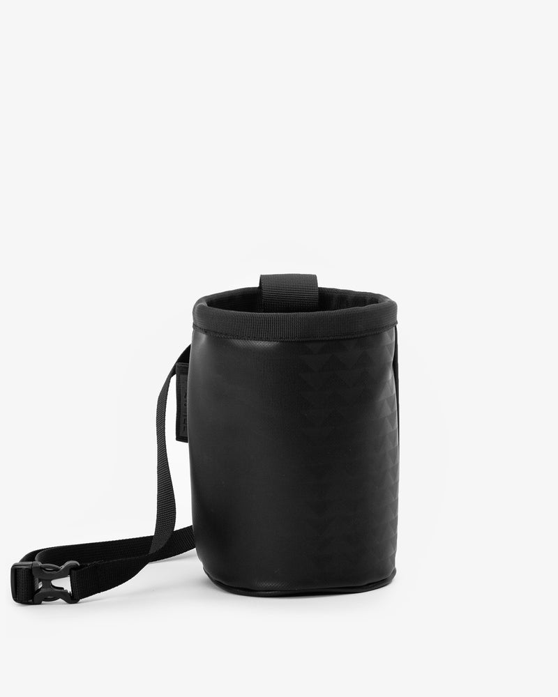 So iLL and On The Roam collaboration black wolf chalk bag with waist belt and cinch closure, designed by Jason Momoa. Front view on grey background.