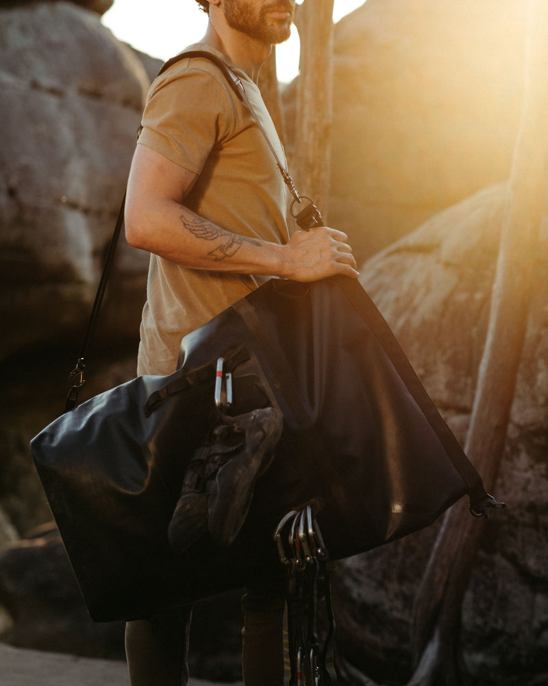 on the roam and so ill collaboration by jason momoa 45L medium black bag on male model