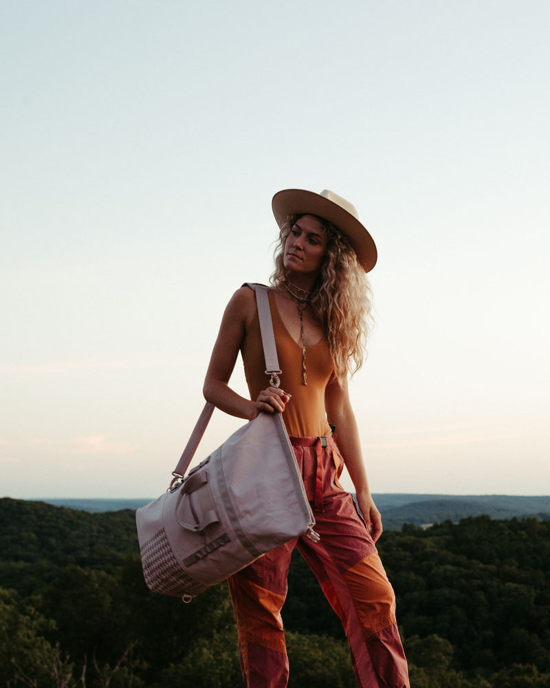 on the roam and so ill collaboration by jason momoa 25L medium pink bag on female model