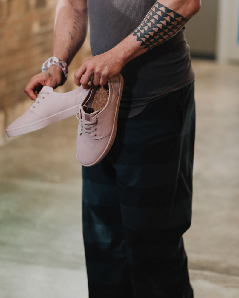 on the roam and so ill collaboration by jason momoa holding pink wolf wino shoes